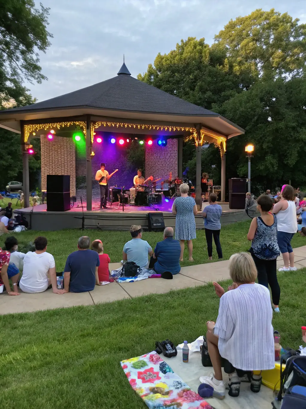 A captivating image of a live music performance in a public space, with a diverse audience enjoying the show, emphasizing the importance of accessible arts and cultural experiences.